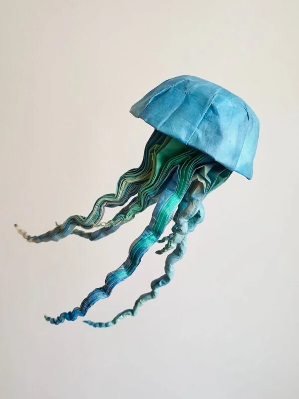 A blue and green origami jellyfish, folded from Lokta paper