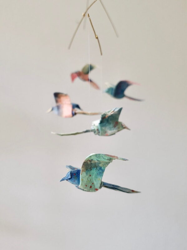 A hanging mobile with colorful origami birds