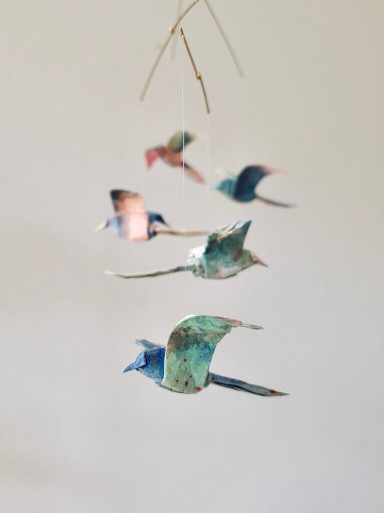 A hanging mobile with colorful origami birds