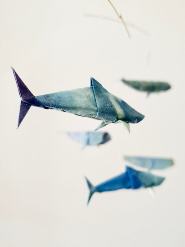 A hangning mobile with origami sharks and whales