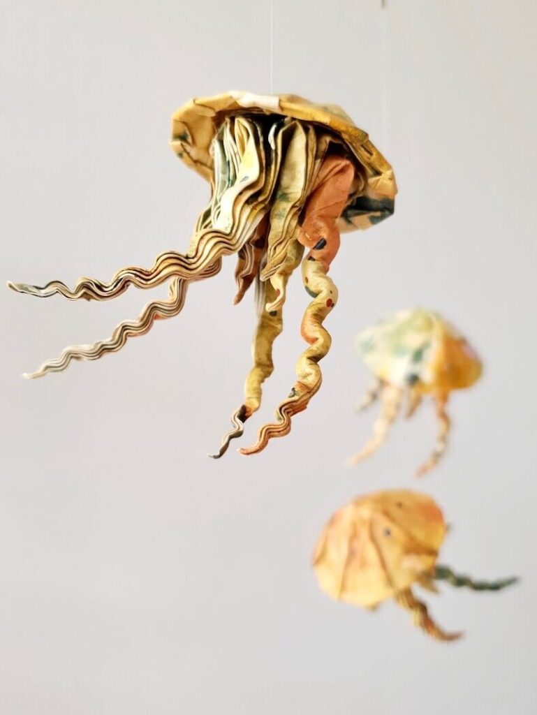 3 origami jellyfish in warm colors
