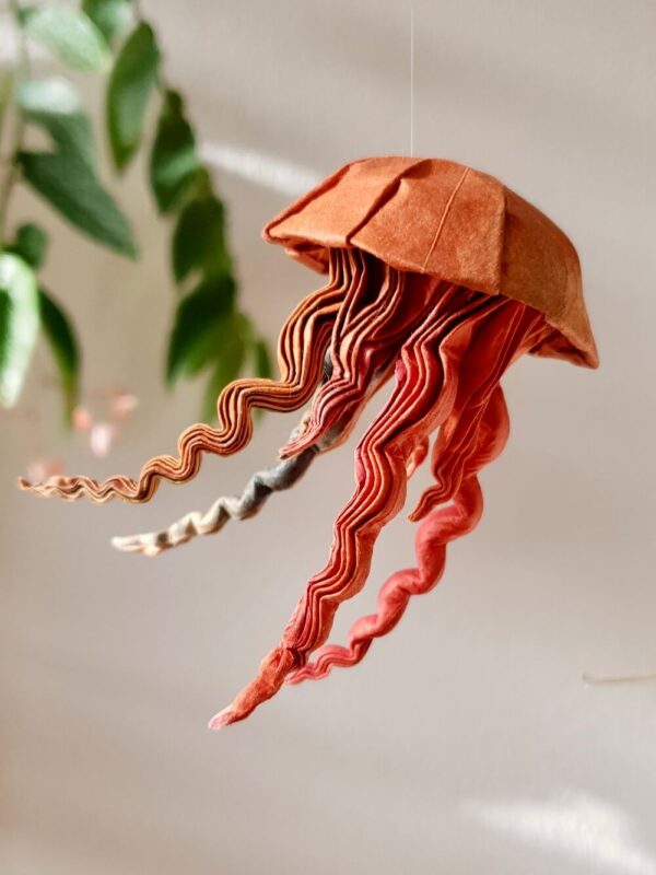 A origami jellyfish folded from custom dyed Washi paper