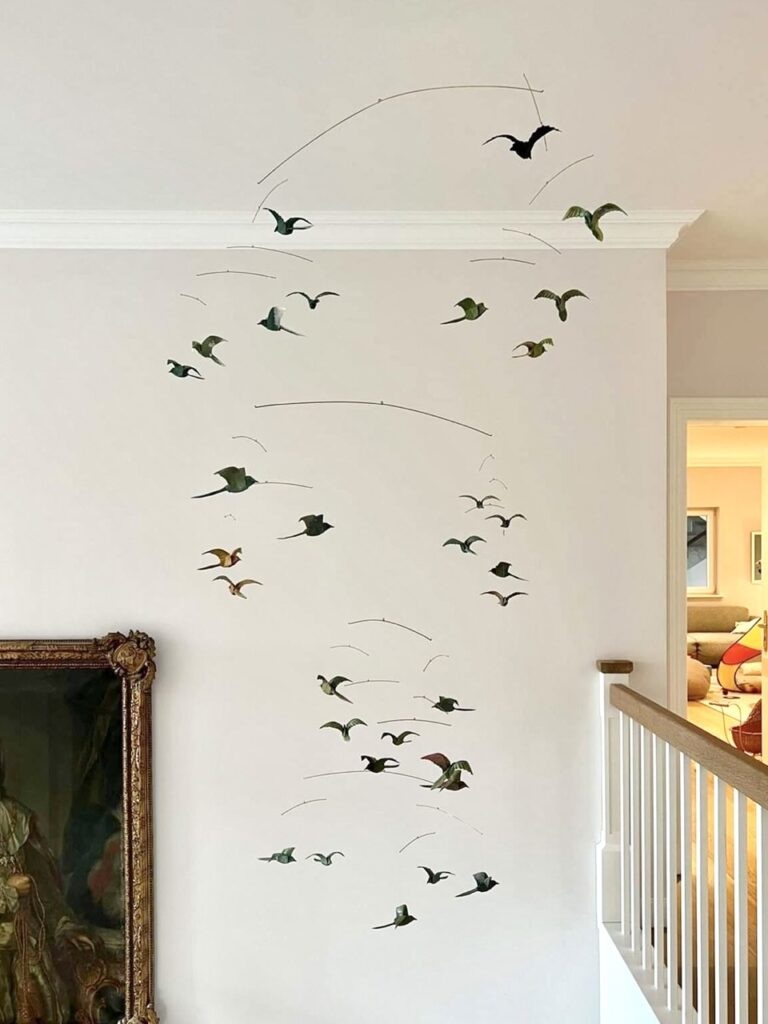 A large hanging mobile with 31 origami birds in various colors.