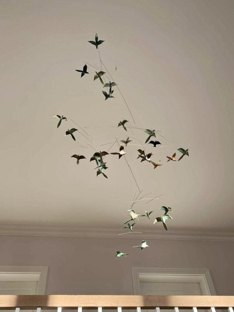 A large hanging mobile with 31 origami birds in various colors.