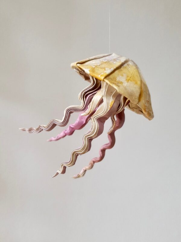 A yellow and pink origami jellyfish