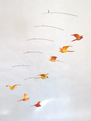 A hanging mobile with 7 orange origami birds